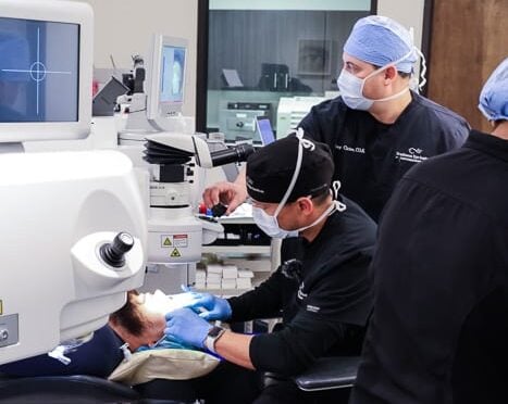 Side view of Dr. De La Torre, MD preforming refractive surgery.