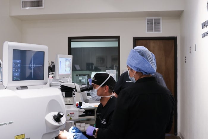 Side view of Dr. De La Torre, MD preforming refractive surgery.