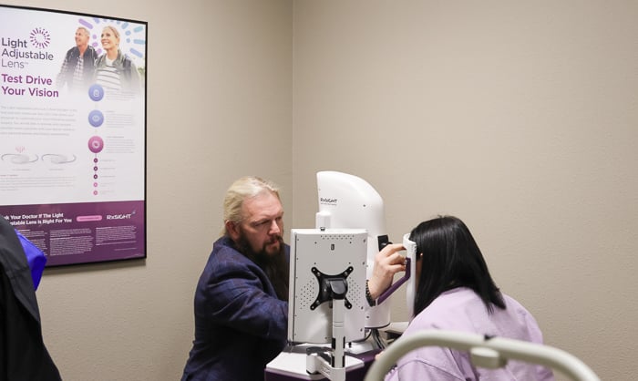 Image of Dr. Lallathin, OD reviewing a patients vision.