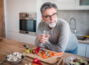 Middle-aged man preparing healthy meals before cataract surgery recovery