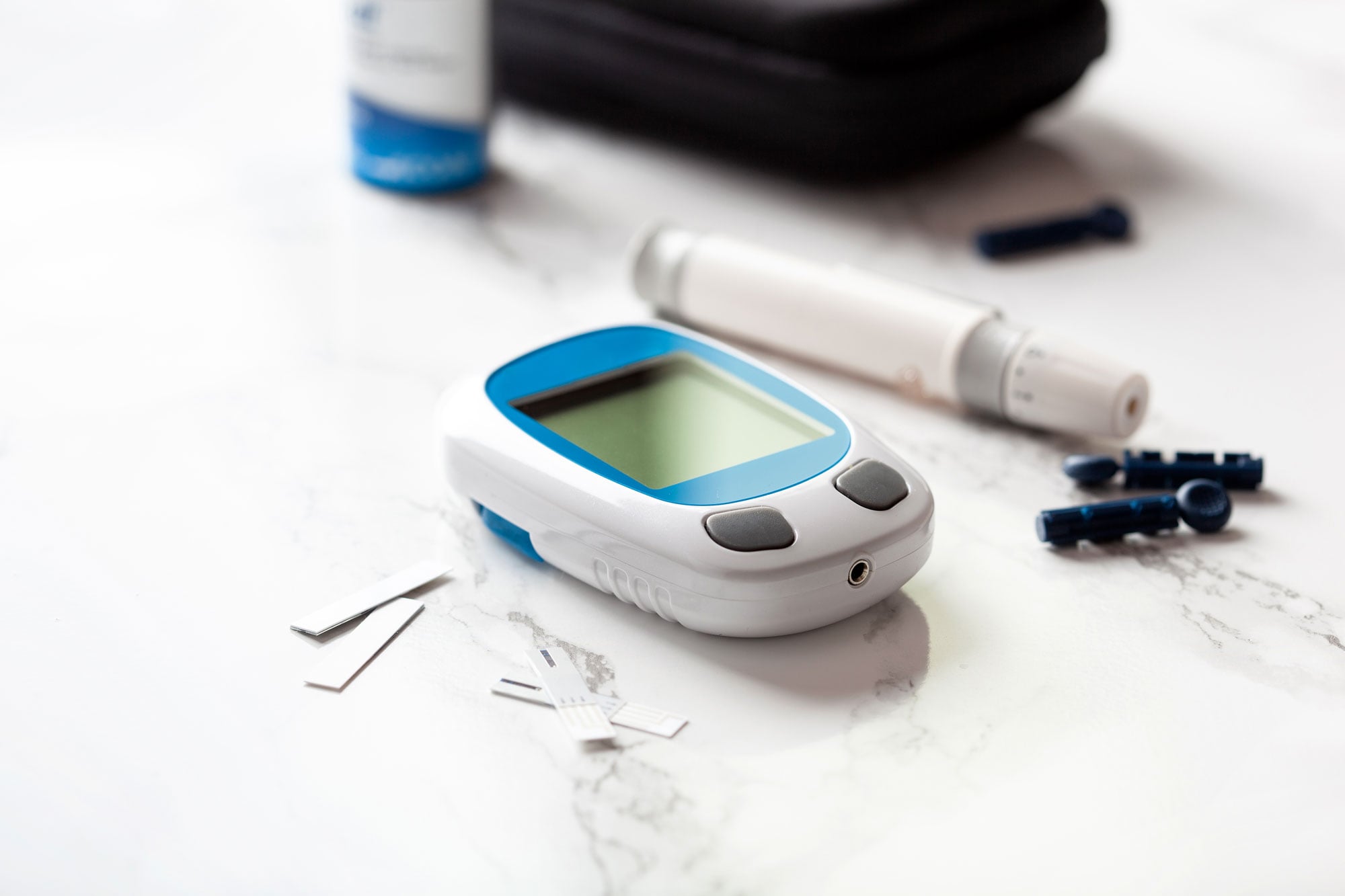 Blood glucose meter, lancet, and test strips representing the risk of vision loss due to diabetes