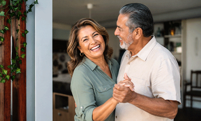 Senior Hispanic couple dancing and laughing after learning about can you reverse cataracts without surgery at Southwest Eye Institute.