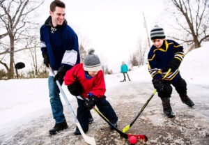 Children playing hockey on ice, showing the importance of eye protection during sports