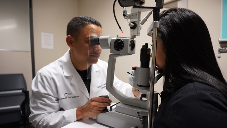 Javier De La Torre conducting a patient exam.