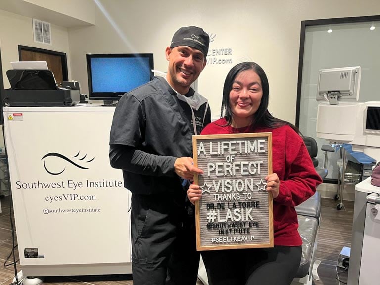 LASIK patient at Southwest Eye Institute holding a “A lifetime of perfect vision” sign after successful LASIK eye surgery, celebrating clear vision in El Paso.