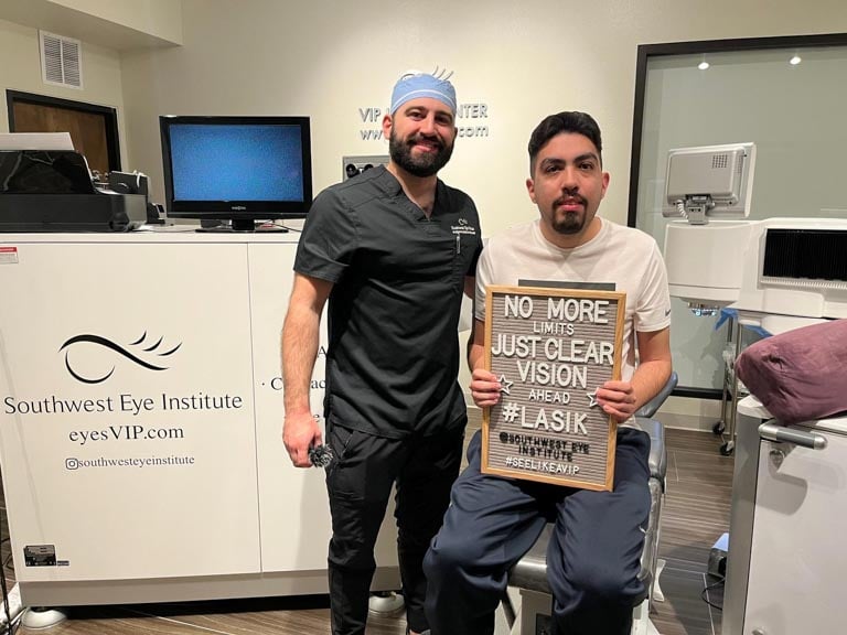 LASIK patient holding a “No more limits, just clear vision” sign alongside Southwest Eye Institute surgeon in El Paso, showcasing successful laser vision correction.