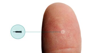 iDose Tr implant shown actual size on a fingertip, is a treatment option if you-have-glaucoma-with-normal-eye-pressure-oct-southwest-eye-institute