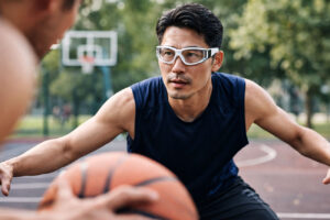 Young man playing basketball without foggy glasses due to a proper fit from Southwest Eye Institute.