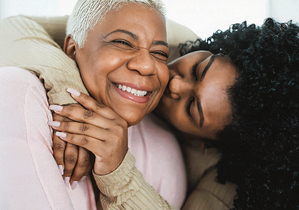 Senior mother embracing her daughter after glaucoma treatment from Southwest Eye Institute.