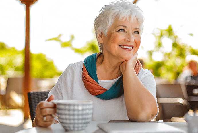 Senior woman enjoying afternoon tea after successful medical-based glaucoma treatment at Southwest Eye Institute.