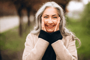 Senior woman happy to be walking in the park after learning more about the common signs of cataracts with Southwest Eye Institute.